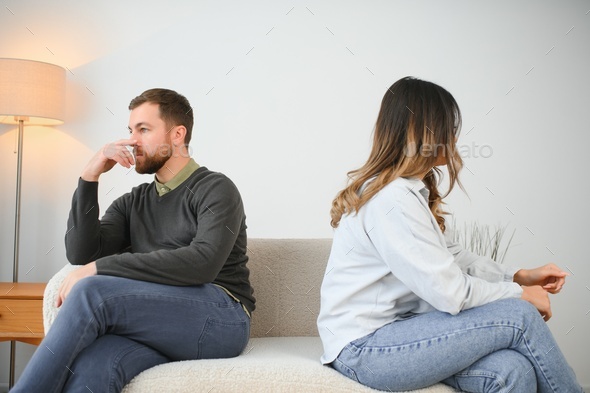 Man and woman feeling stressed and angry at each other, frustrated couple sitting back to back, family crisis and relationships problems.